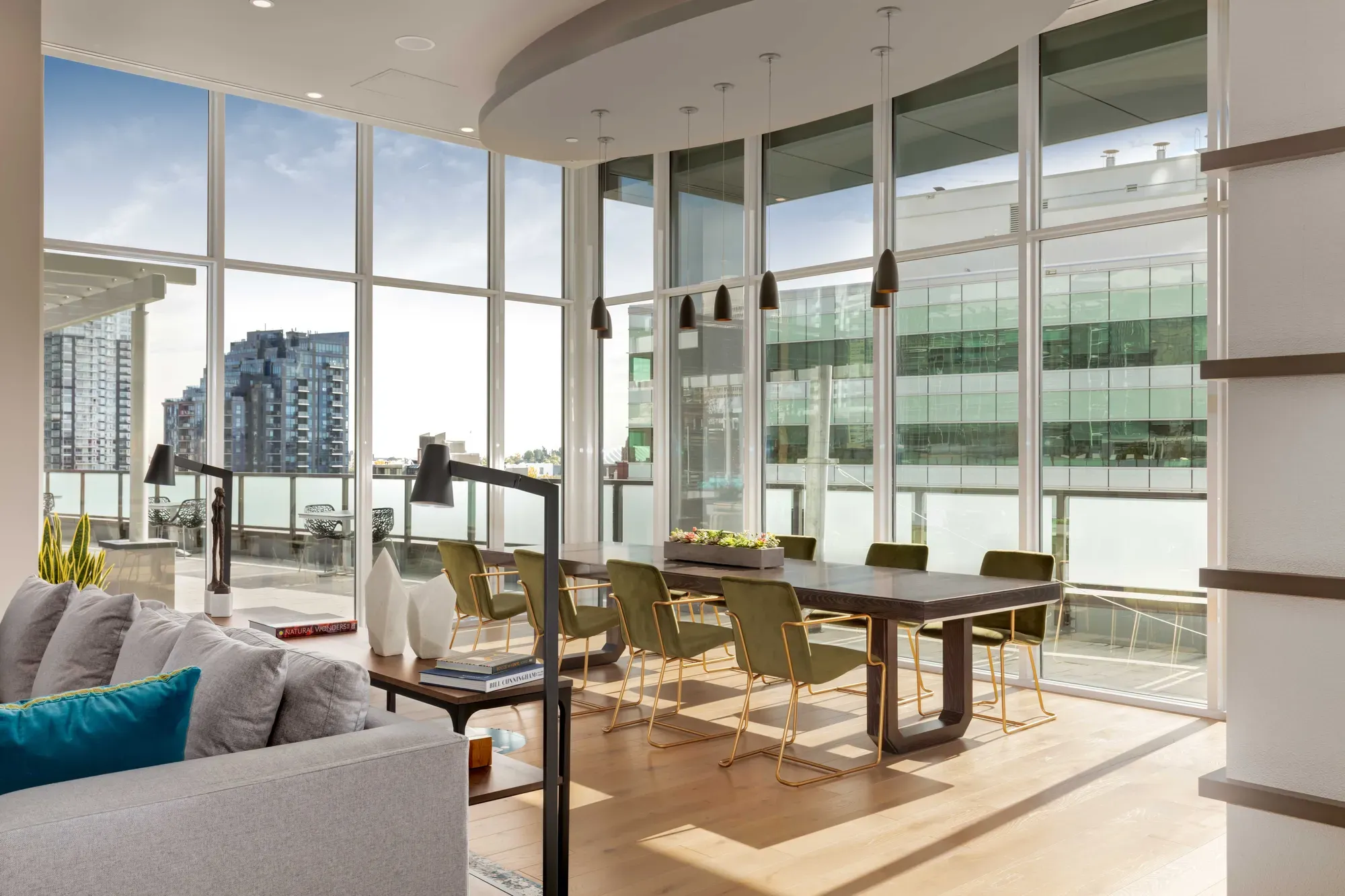 Spacious modern dining area with city views through floor-to-ceiling windows.